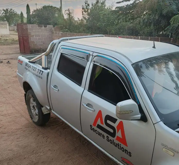 Silver patrol pickup with ASA Secure Solutions livery on the door