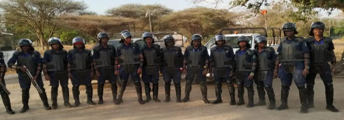 ASA Quick Response Force officers in protective gear lined up in front of response vehicles