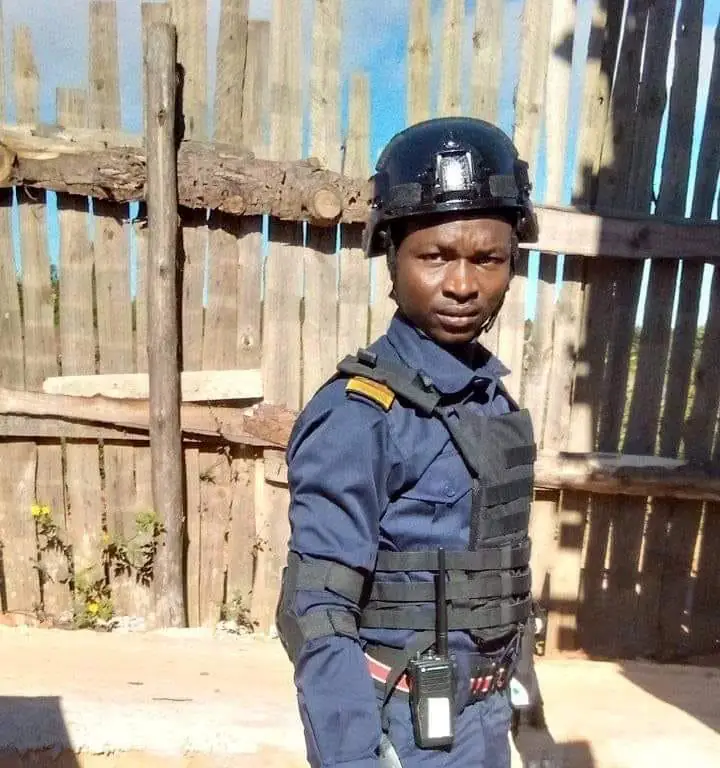 ASA security officer in helmet and protective vest standing at a site post