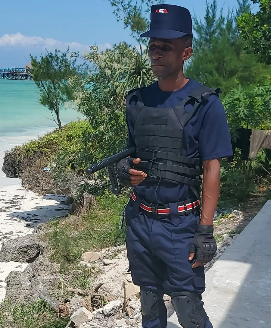 ASA security officer in navy uniform and protective vest on duty at a coastal property